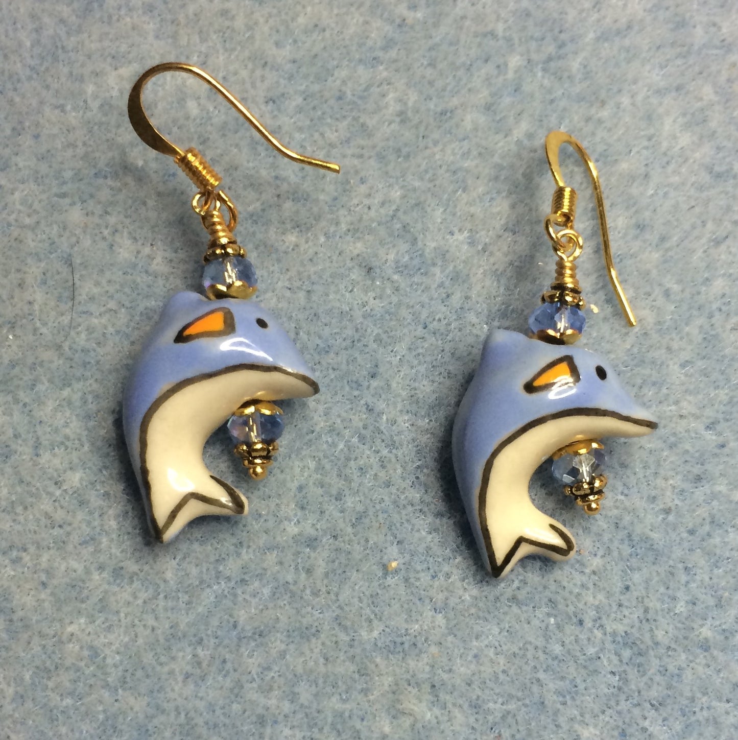 Light blue ceramic dolphin bead earrings adorned with light blue Chinese crystal beads.