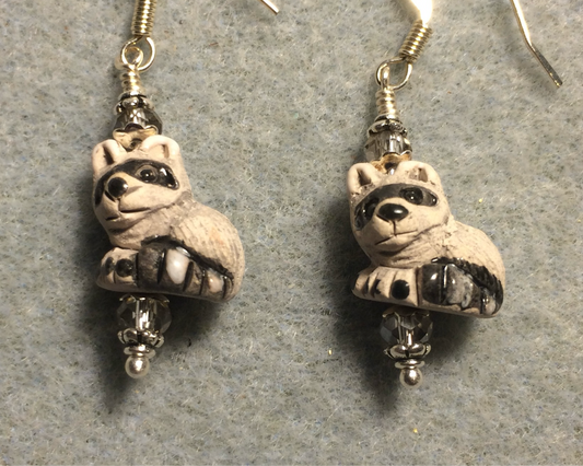Small black and gray ceramic raccoon bead earrings adorned with gray Chinese crystal beads.