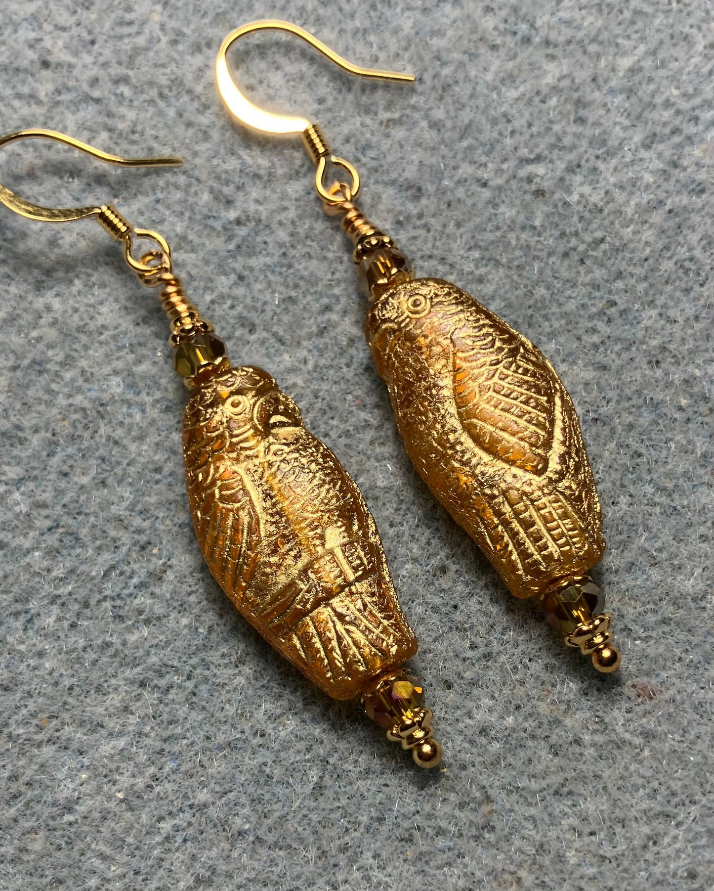Large amber (with gold wash) Czech glass parrot bead earrings adorned with amber Chinese crystal beads.