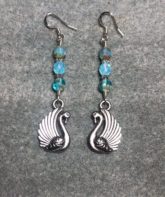 Silver swan charm earrings adorned with milky turquoise Czech glass beads.