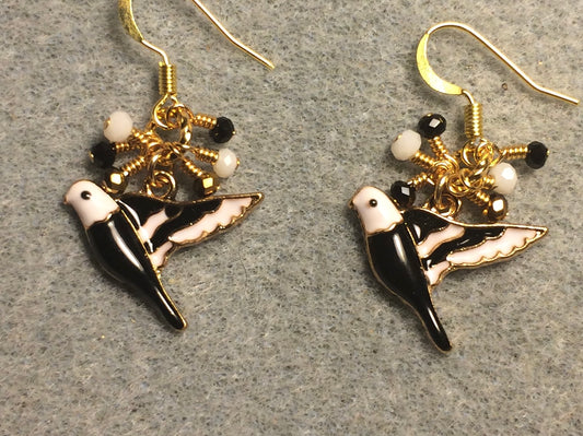 Black, white, and gold enamel parakeet charm earrings adorned with tiny dangling black, white, and gold Chinese crystal beads.