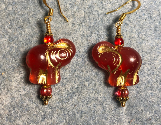 Orange red (with gold inlay) Czech glass elephant bead earrings adorned with orange red Czech glass beads.