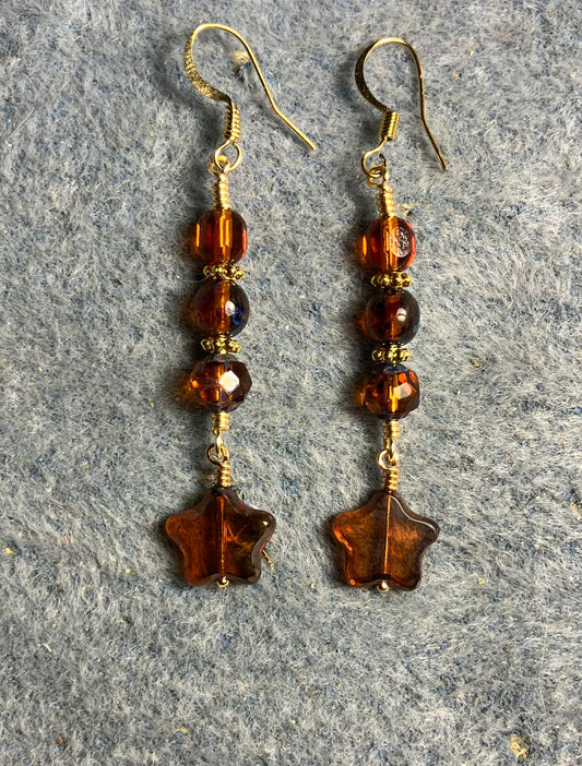 Small translucent dark amber Czech glass star bead earrings adorned with dark amber Czech glass beads.