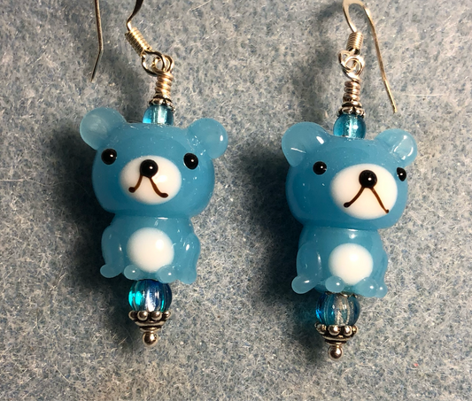 Opaque turquoise and white lamp work teddy bear bead earrings adorned with turquoise Czech glass beads.