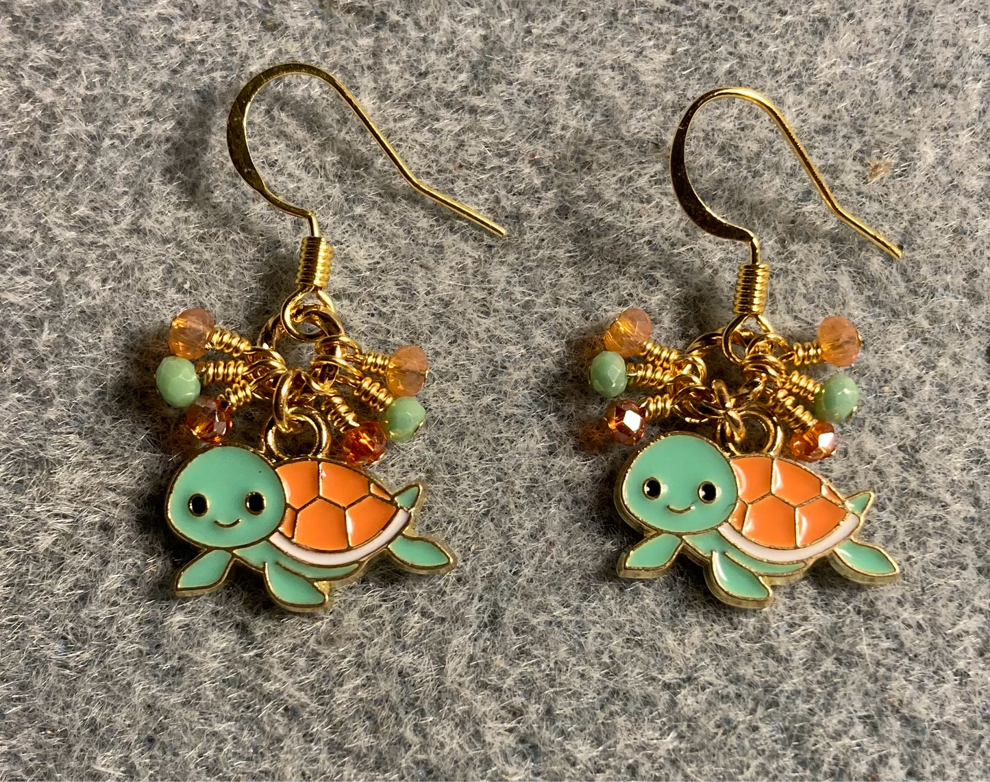 Small green and orange enamel turtle charm earrings adorned with tiny dangling green and orange Chinese crystal beads.