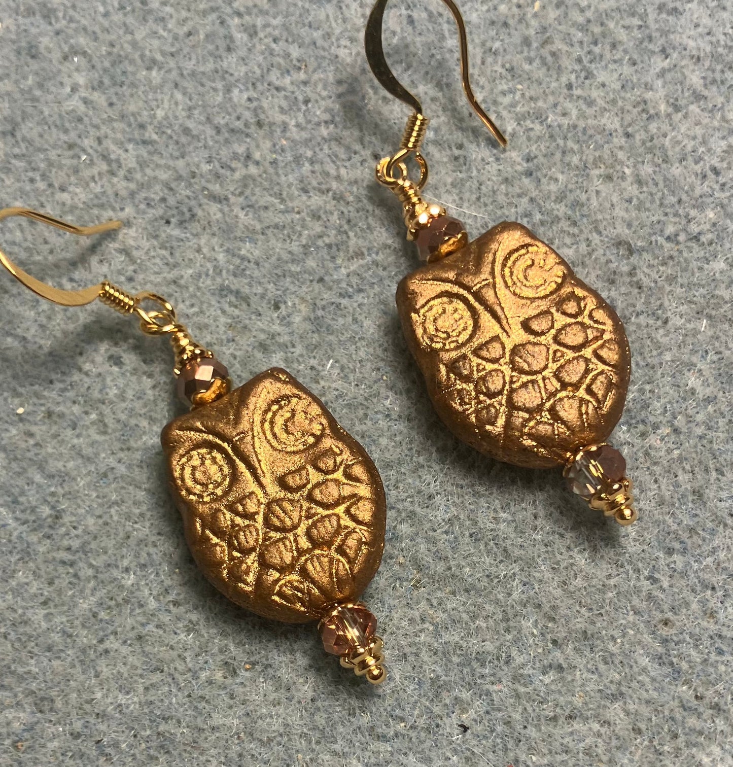 Gold Czech glass owl bead earrings adorned with gold Chinese crystal beads.