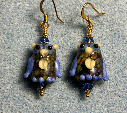 Blue and yellow lamp work owl bead earrings adorned with blue Chinese crystal beads.