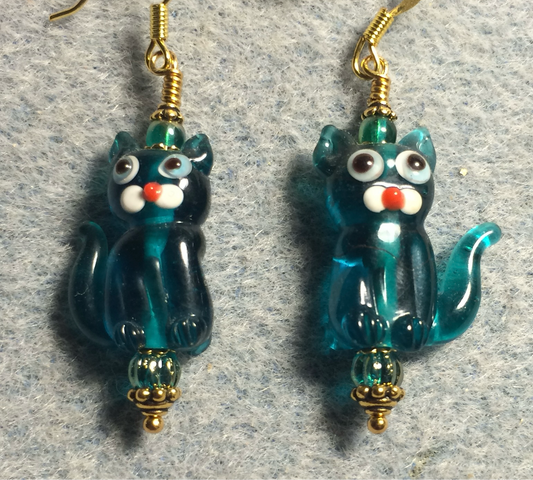Translucent teal lamp work cat bead earrings adorned with teal Czech glass beads.