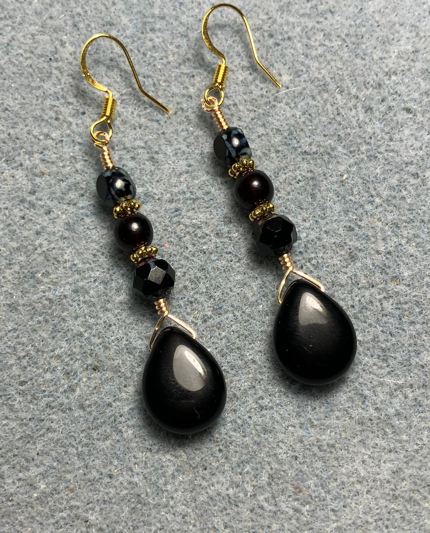 Black Czech glass pear drop bead earrings adorned with black Czech glass beads.