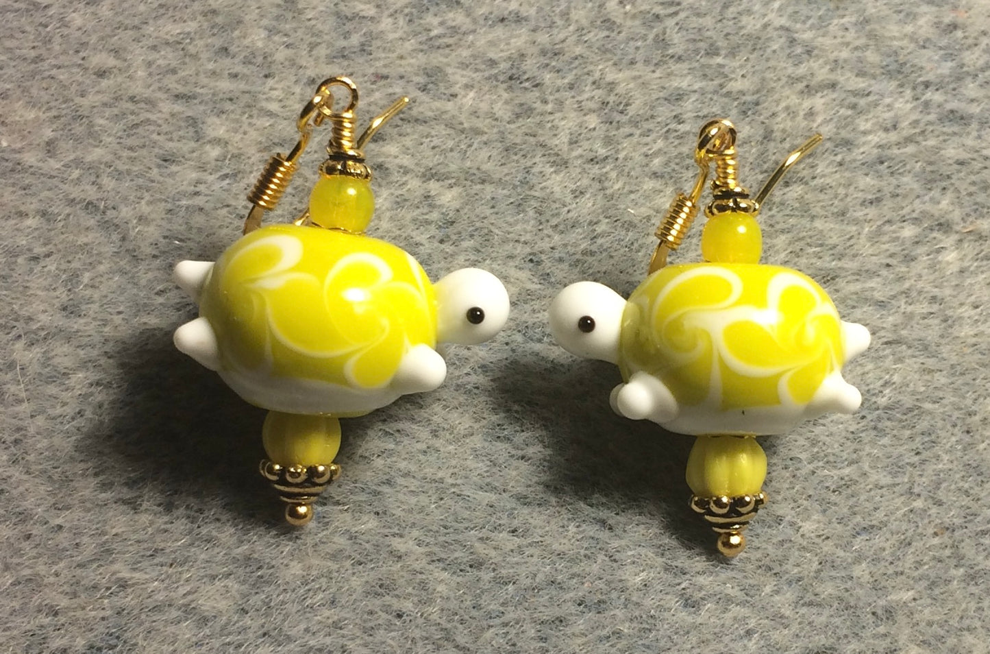 Yellow lamp work spotted turtle bead earrings adorned with yellow Czech glass beads.