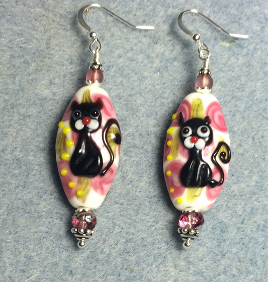 Pink, black, and white lamp work cat bead earrings adorned with pink Czech glass beads.