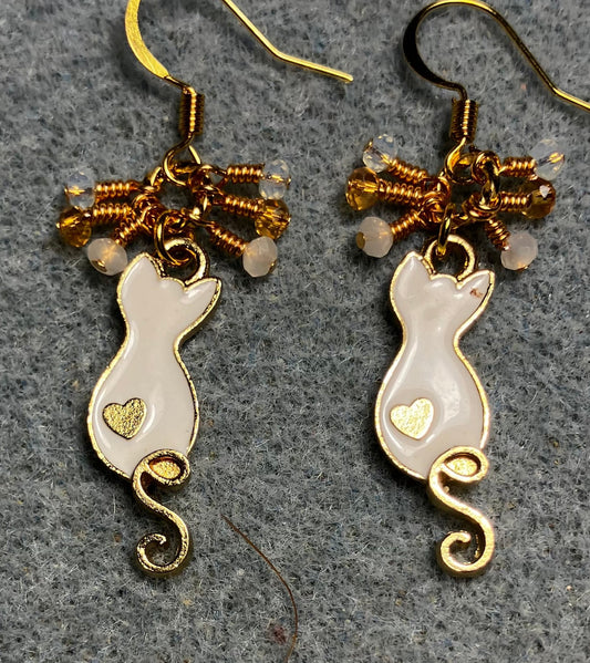 Small white and gold enamel curly tailed cat charm earrings adorned with tiny dangling white, amber, and clear Chinese crystal beads.