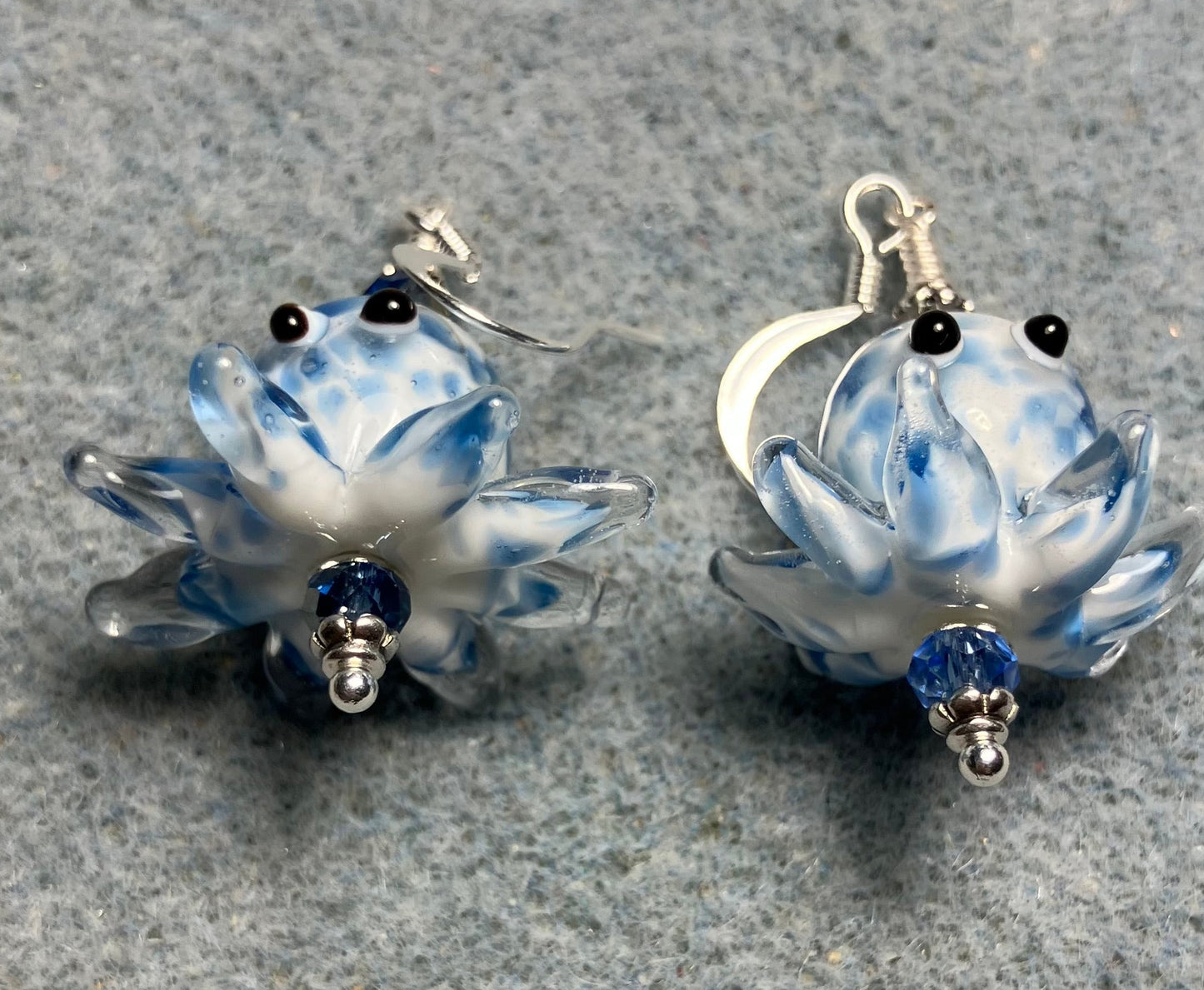 Blue and white mottled lamp work octopus bead earrings adorned with light blue Chinese crystal beads.