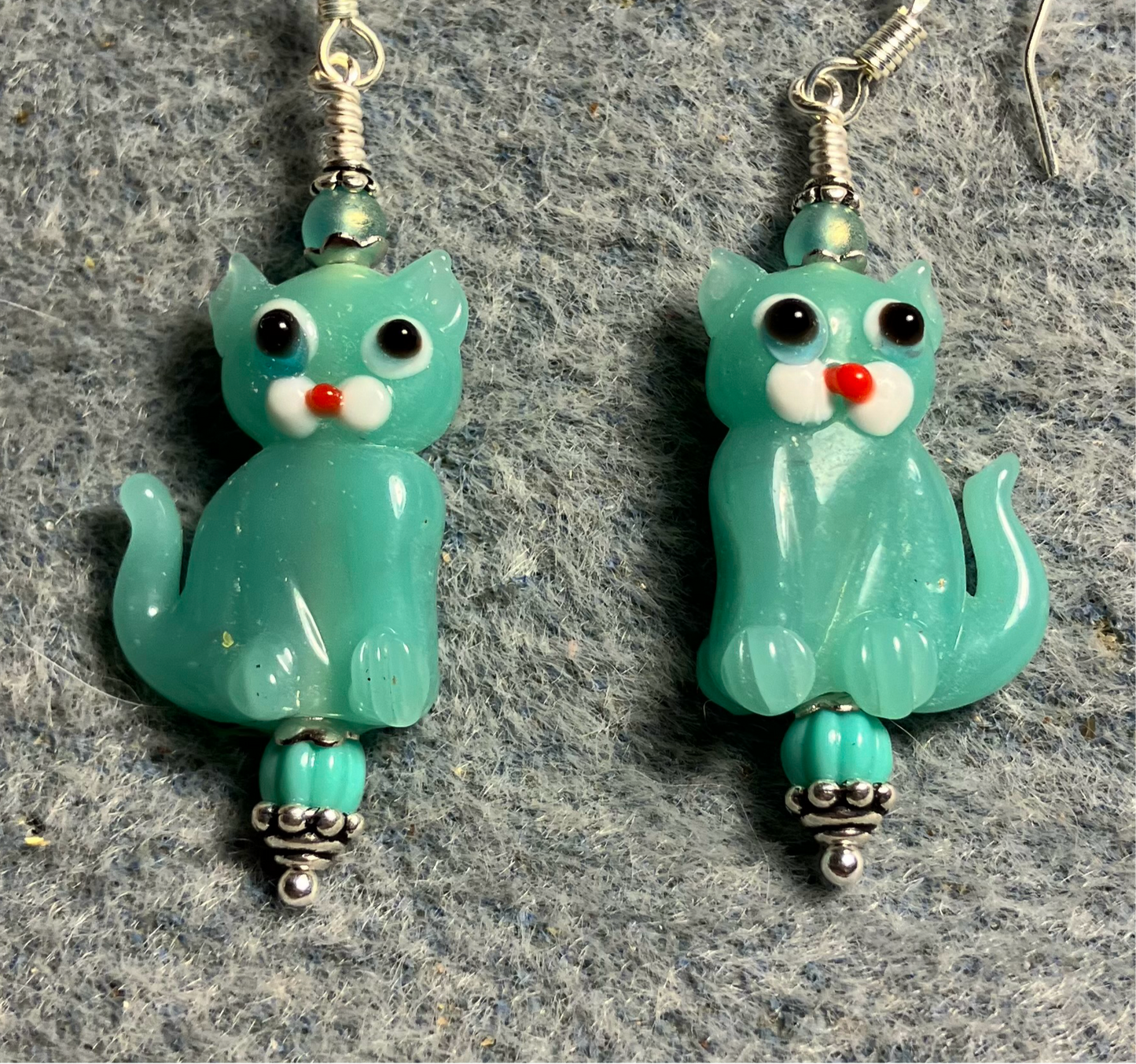 Milky turquoise lamp work cat bead earrings adorned with turquoise Czech glass beads.