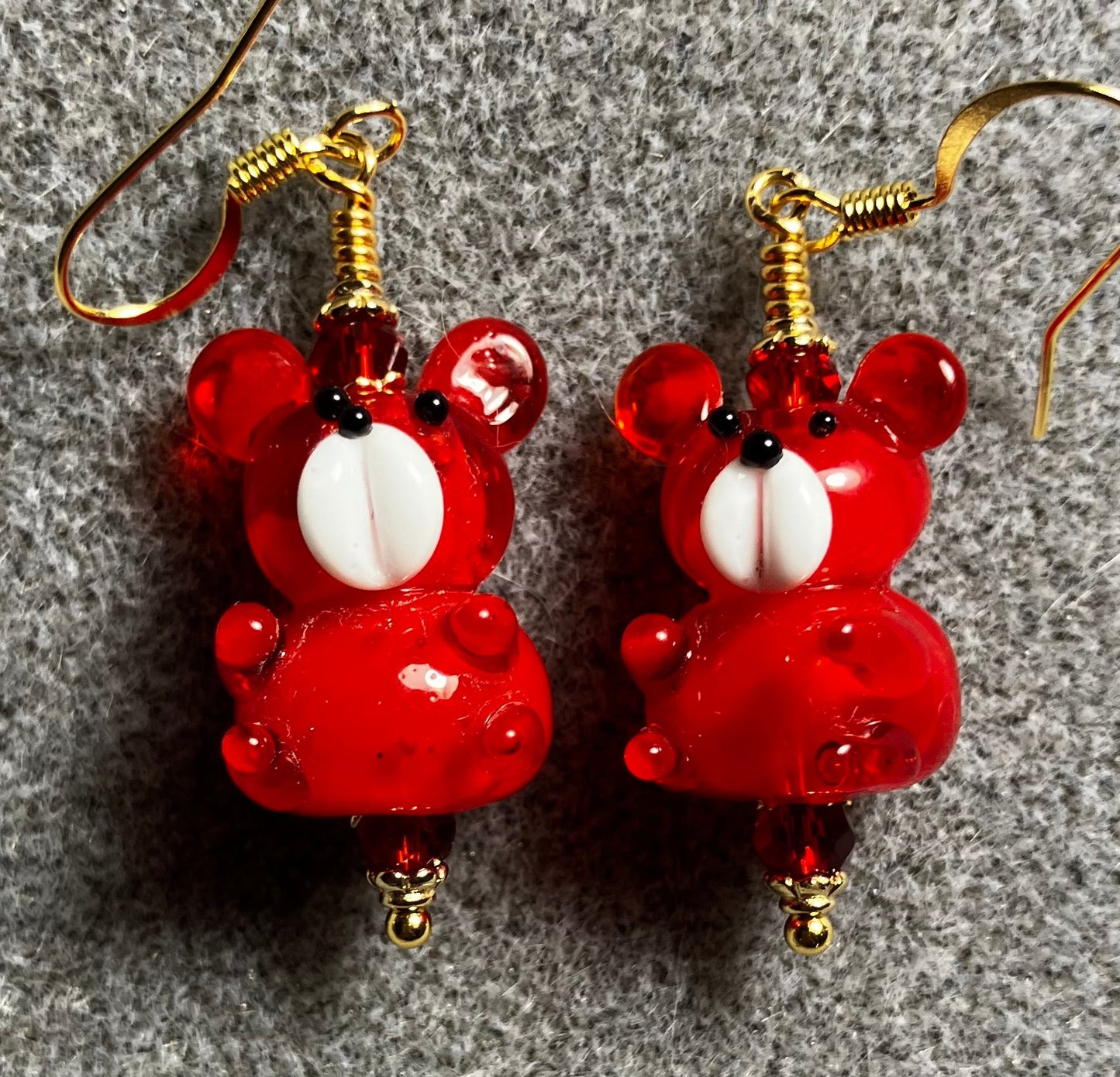 Bright red and white lamp work teddy bear bead earrings adorned with bright red Chinese crystal beads.