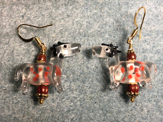 Translucent clear and orange  lamp work spotted horse bead earrings adorned with burnt orange Czech glass beads.