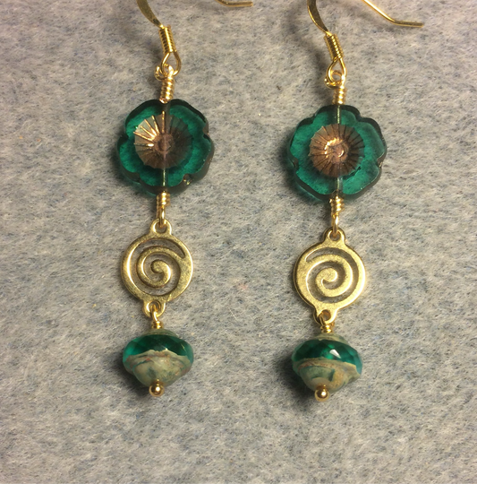 Translucent teal and gold Czech glass pansy bead earrings adorned with gold swirly connectors and teal Czech glass Saturn beads.