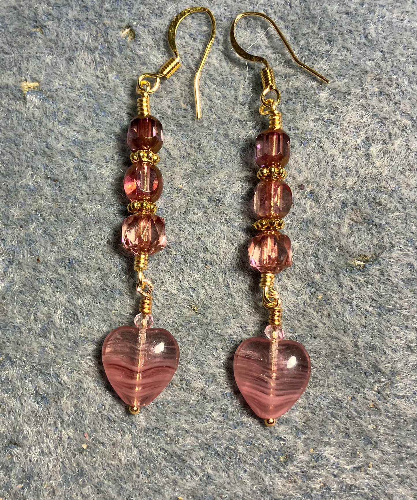 Small violet pink Czech glass heart bead earrings adorned with violet pink Czech glass beads.