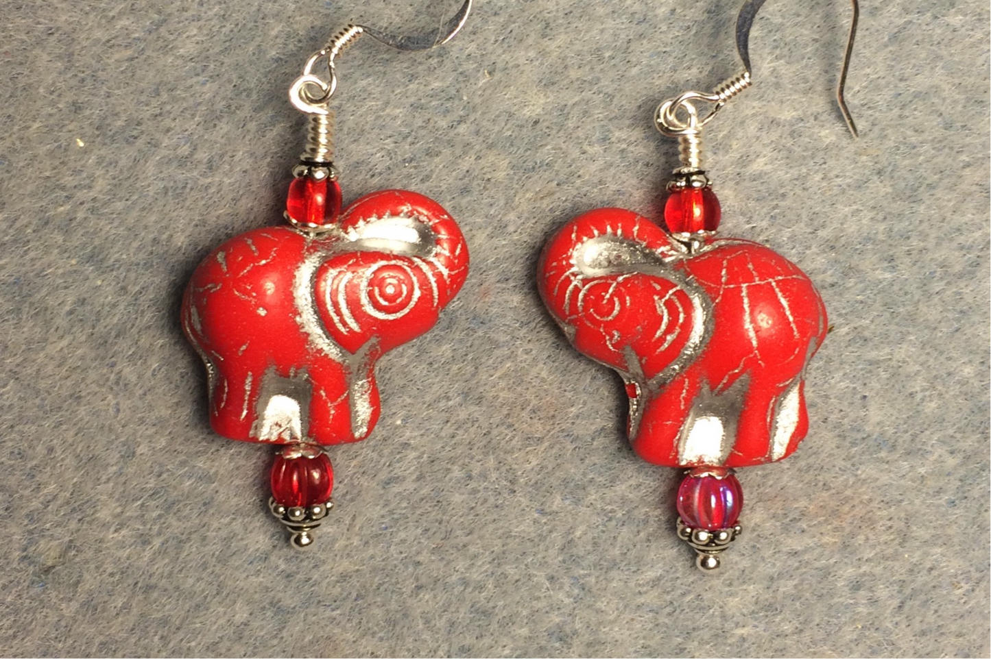 Opaque red (with silver inlay) Czech glass elephant bead earrings adorned with red Czech glass beads.