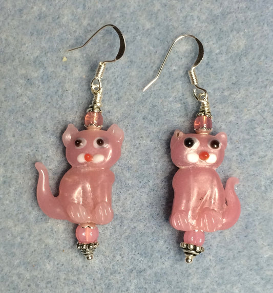 Opaque pink lamp work cat bead earrings adorned with pink Czech glass beads.