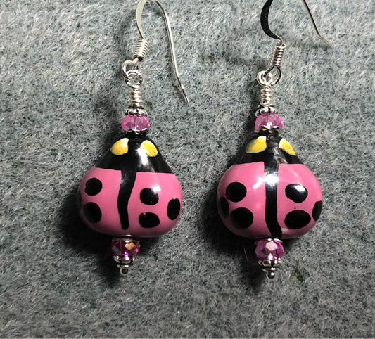 Hot pink and black ceramic ladybug bead earrings adorned with hot pink Chinese crystal beads.