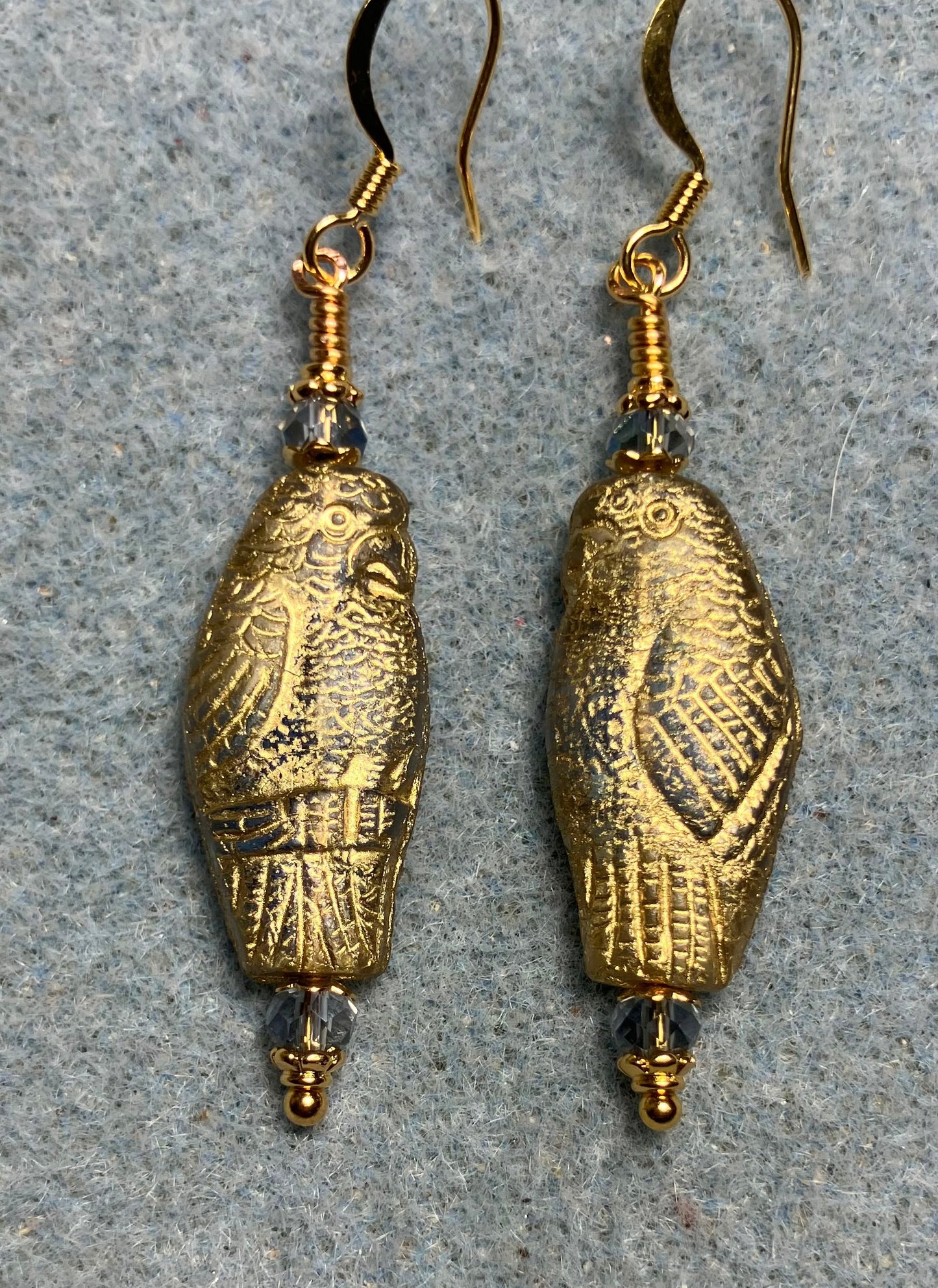 Large light blue (with gold wash) Czech glass parrot bead earrings adorned with light blue Chinese crystal beads.