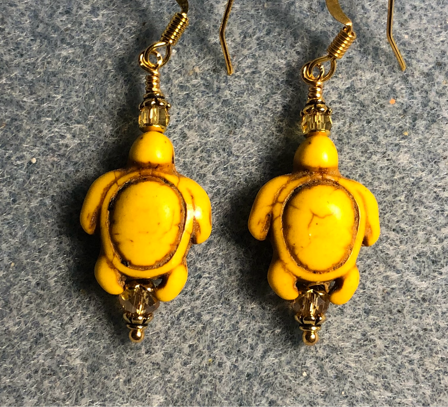 Yellow howlite gemstone turtle bead earrings adorned with yellow Chinese crystal beads.