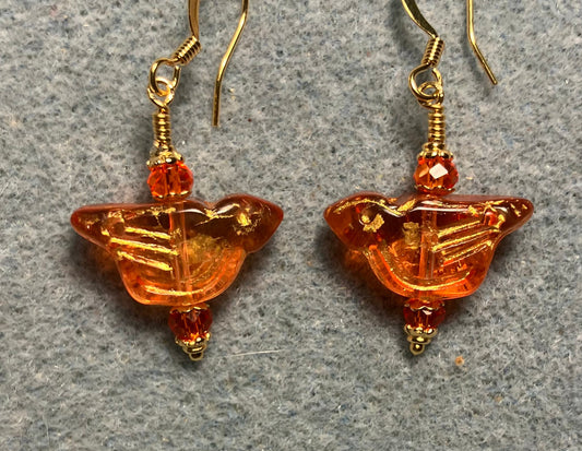 Translucent orange (with gold wash) Czech glass bird bead earrings adorned with orange Chinese crystal beads.