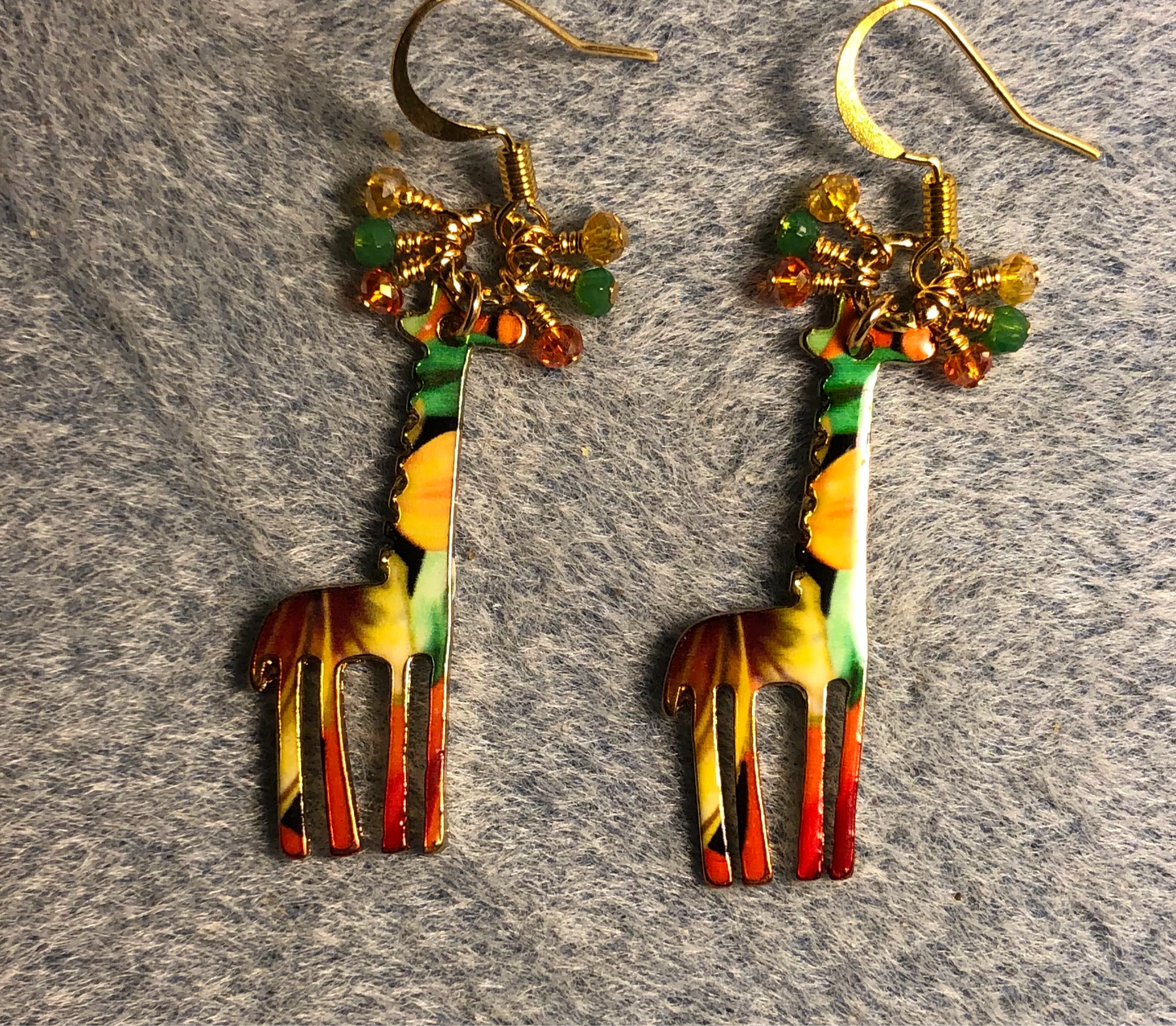 Orange, green, and amber enamel giraffe charm earrings adorned with tiny dangling orange, green, and amber Chinese crystal beads.