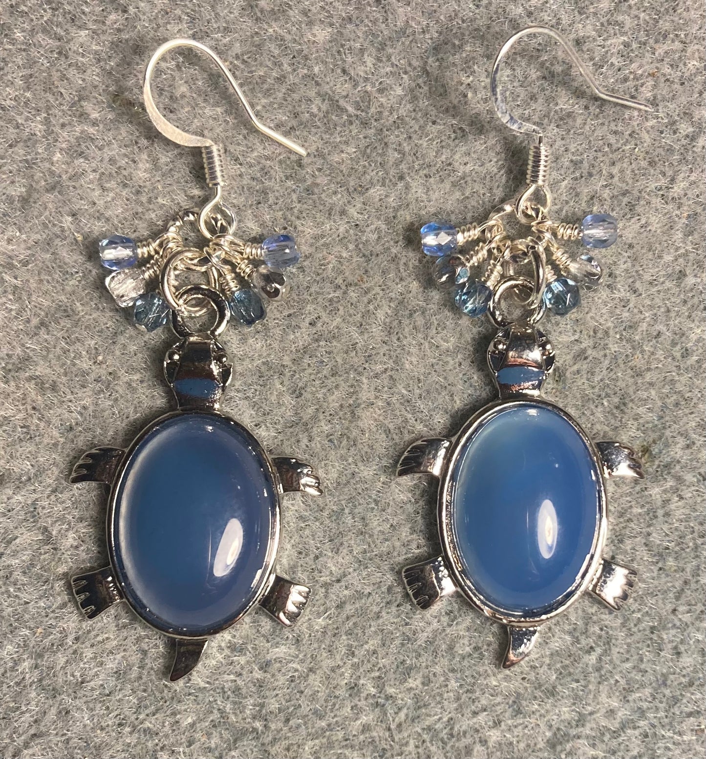 Large silver and blue agate gemstone turtle charm earrings adorned with small dangling blue and silver Czech glass beads.