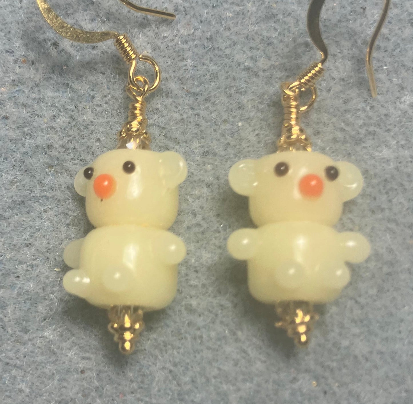 Small light yellow lamp work teddy bear bead earrings adorned with light yellow Chinese crystal beads.