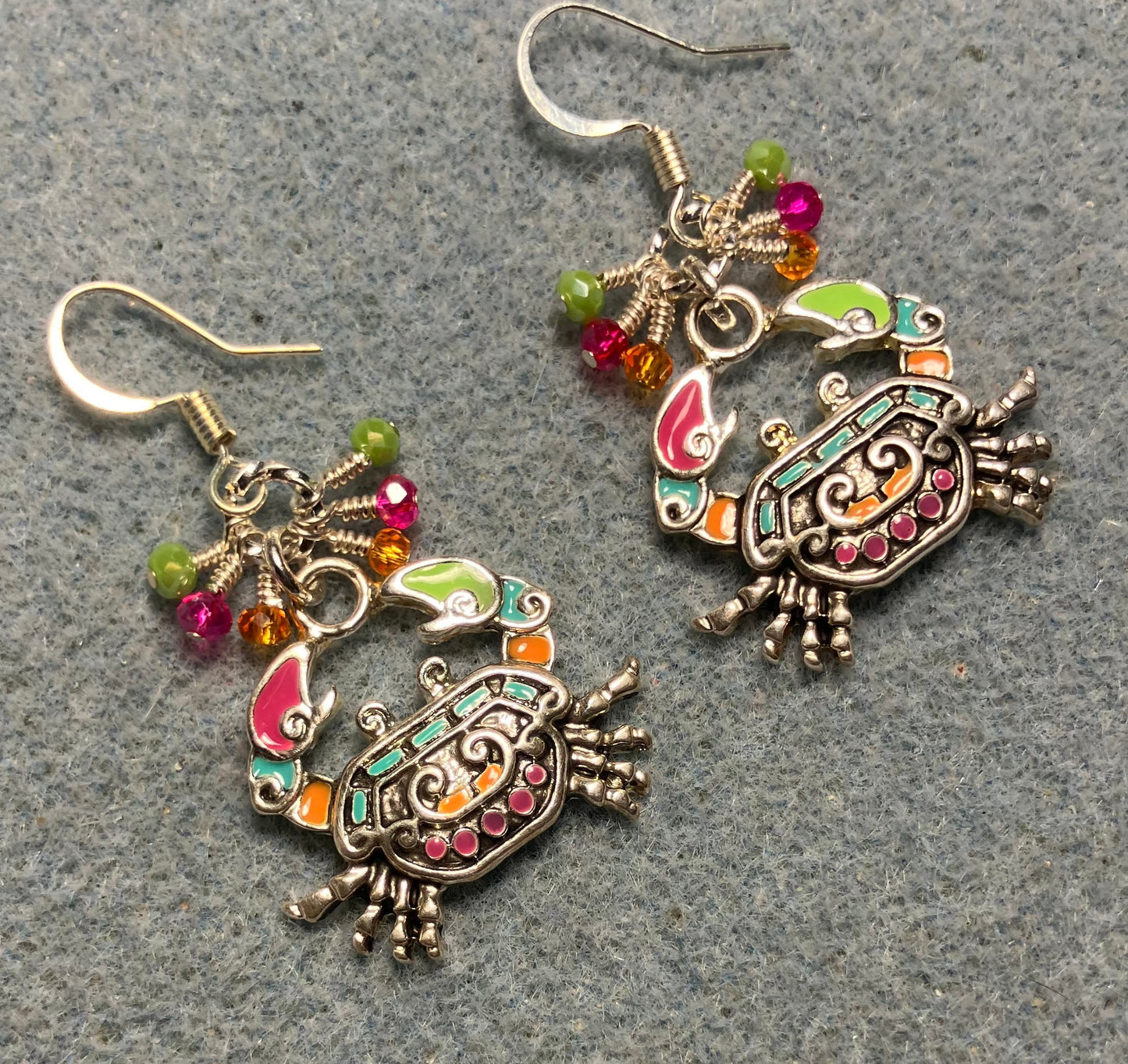 Orange, pink, and green enamel crab charm earrings adorned with tiny dangling orange, pink, and green Chinese crystal beads.