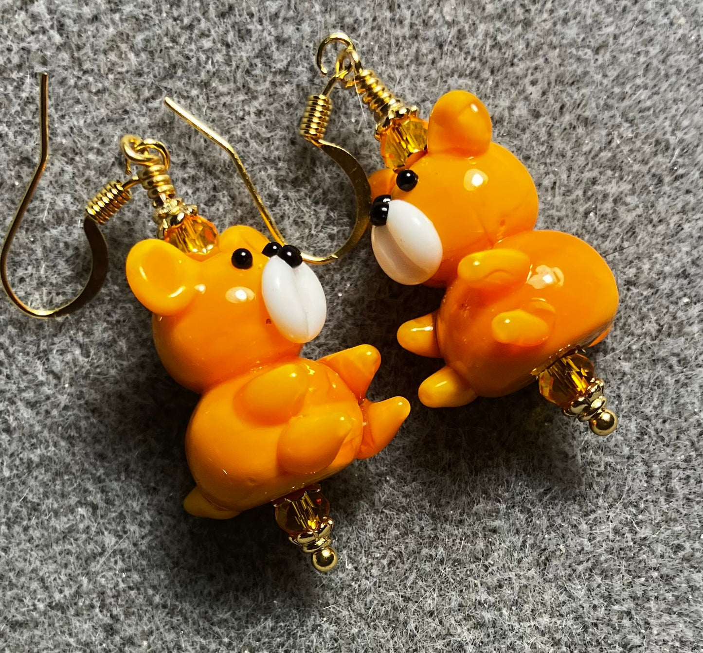 Tangerine and white lamp work teddy bear bead earrings adorned with tangerine Chinese crystal beads.