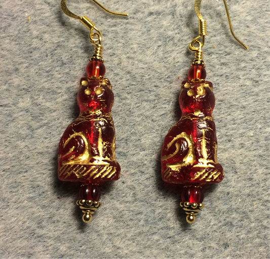 Translucent red (with gold inlay) fancy Czech glass cat bead earrings adorned with red Czech glass beads.