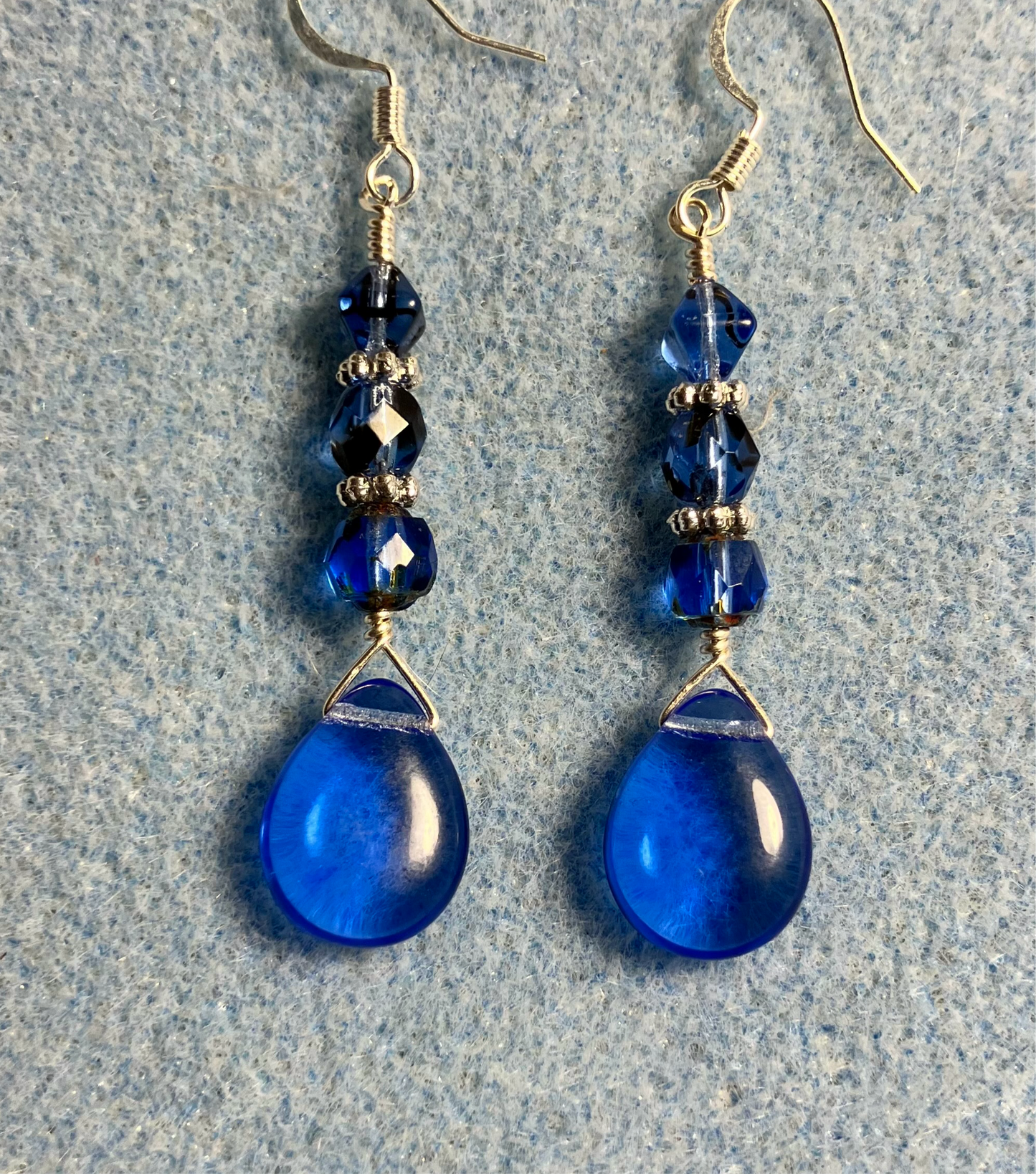 Translucent blue Czech glass pear drop bead earrings adorned with blue Czech glass beads.