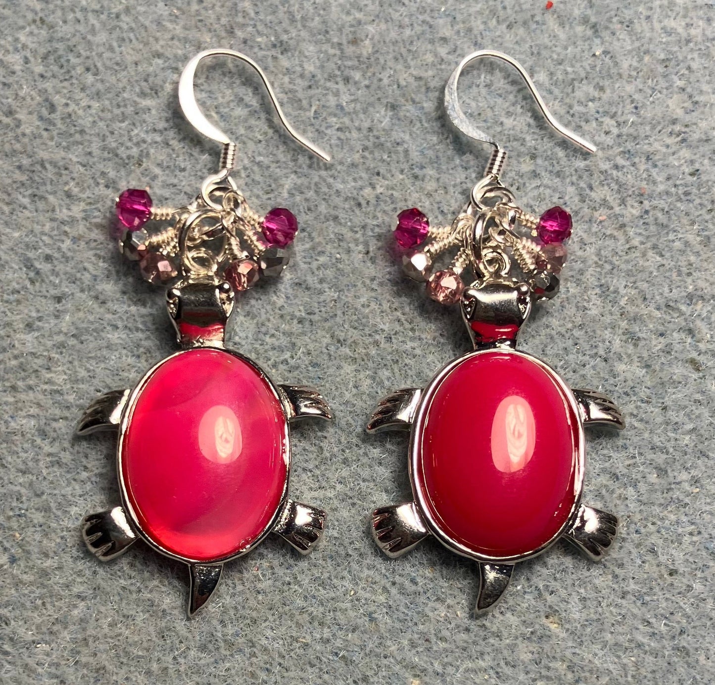 Large silver and hot pink agate gemstone turtle charm earrings adorned with small dangling hot pink, pink, and silver Chinese crystal beads.