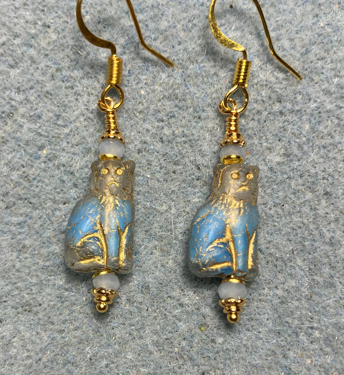 Small light blue and gold Czech glass cat bead earrings adorned with light blue Chinese crystal beads.