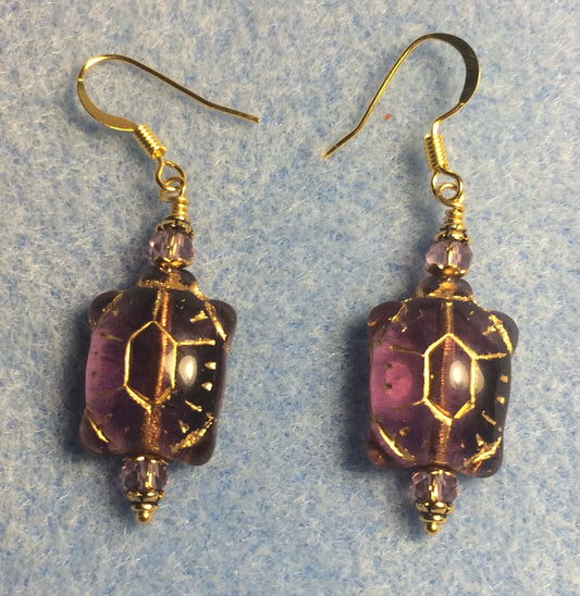 Purple (with gold inlay) Czech glass turtle bead earrings adorned with purple Chinese crystal beads.