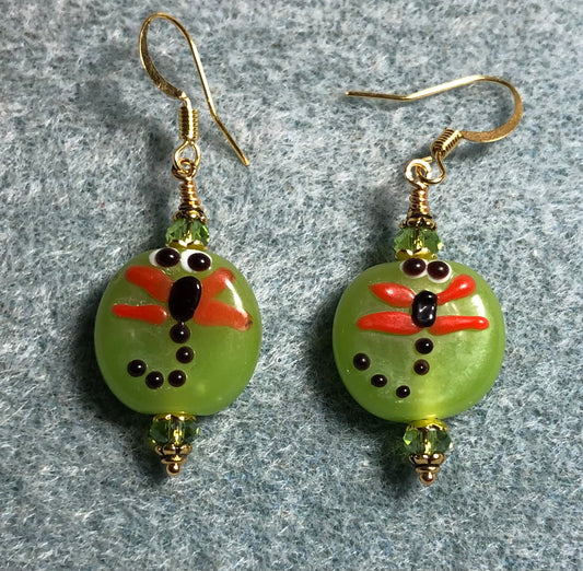 Olive green and orange lamp work dragonfly bead earrings adorned with olive green Chinese crystal beads.