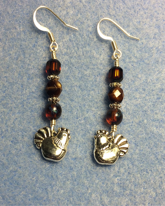 Silver chicken charm earrings adorned with brown Czech glass beads