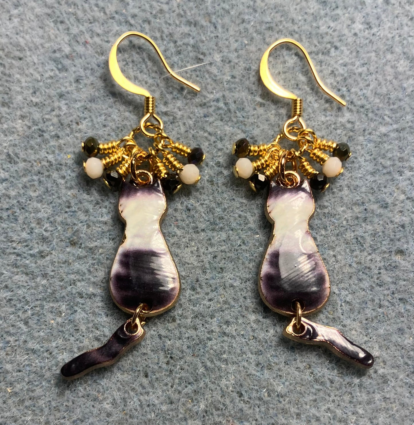 Gray and white enamel cat charm earrings adorned with tiny dangling gray and white Chinese crystal beads.