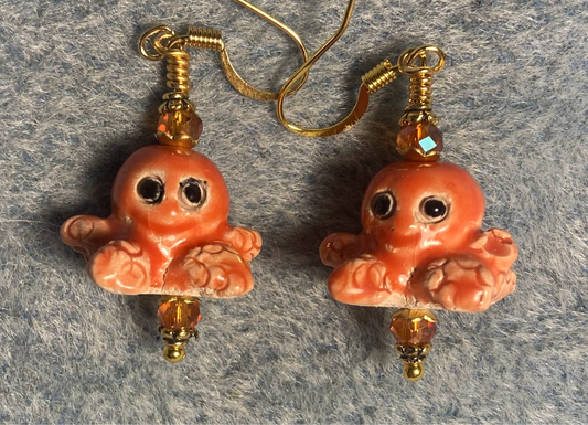 Orange peach ceramic octopus bead earrings adorned with orange Chinese crystal beads.