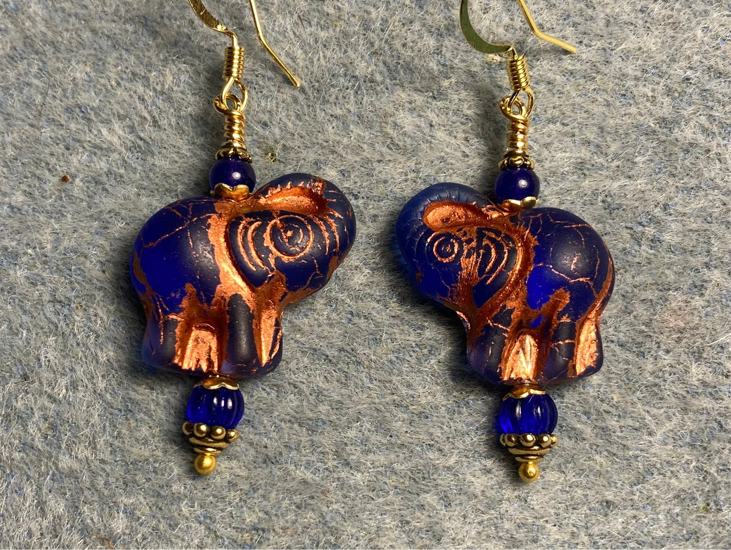 Translucent dark blue (with copper inlay) Czech glass elephant bead earrings adorned with dark blue Czech glass beads.