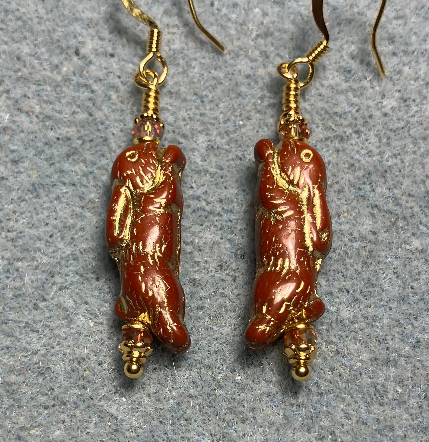 Small dark orange (with gold inlay) Czech glass bunny rabbit bead earrings adorned with orange Chinese crystal beads.