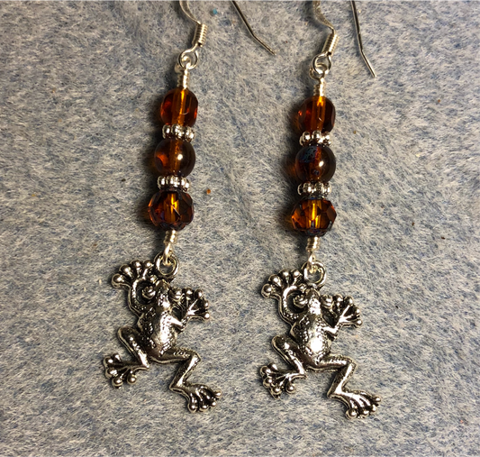 Silver frog charm earrings adorned with topaz Czech glass beads.