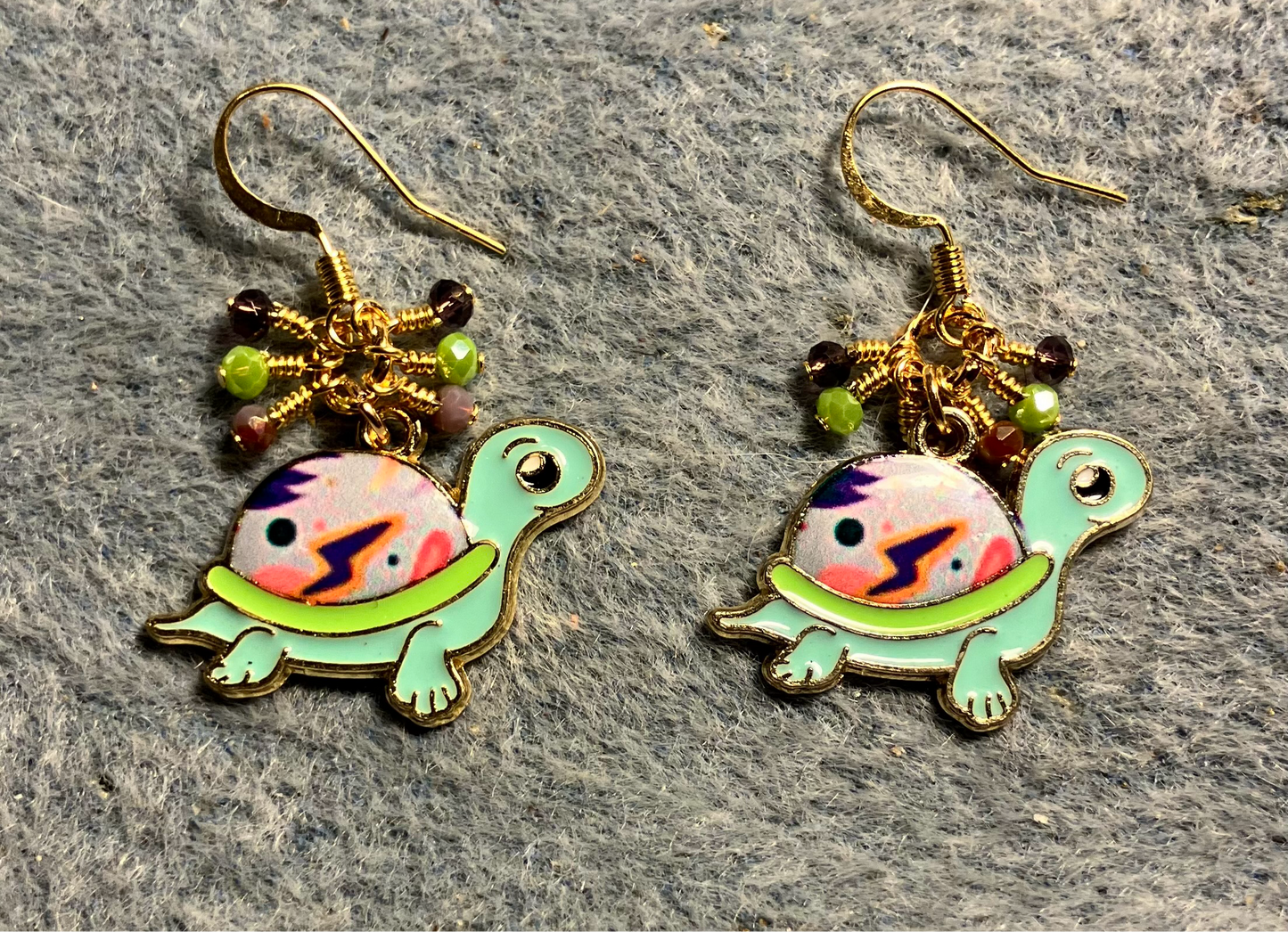 Violet and green enamel turtle charm earrings adorned with tiny dangling violet, lime green and purple Chinese crystal beads.