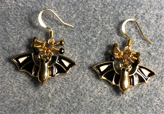 Black and gold enamel bat charm earrings adorned with tiny dangling black and gold Chinese crystal beads.