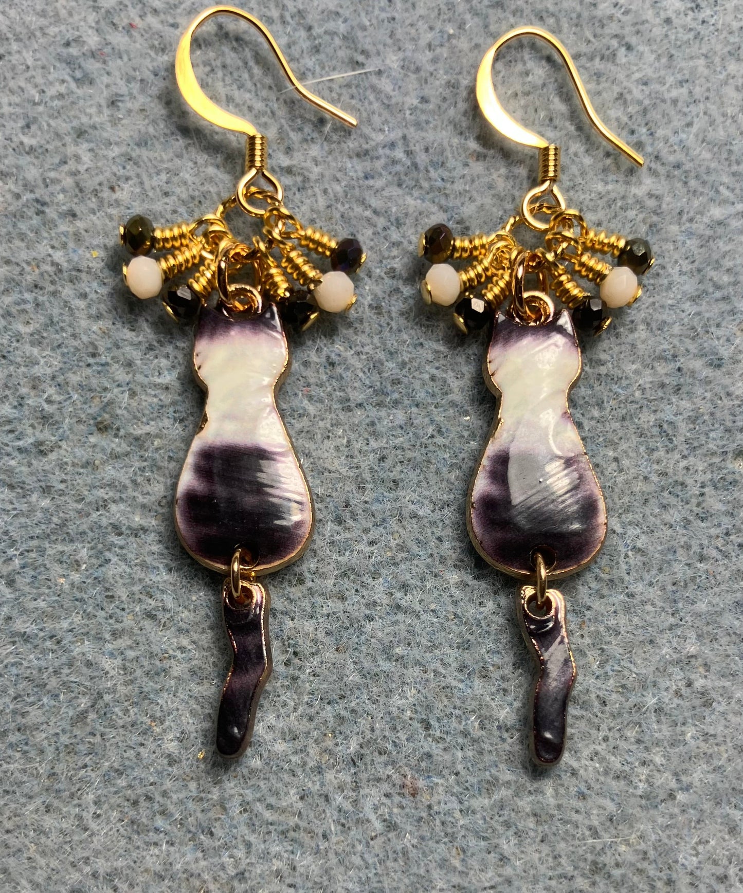 Gray and white enamel cat charm earrings adorned with tiny dangling gray and white Chinese crystal beads.