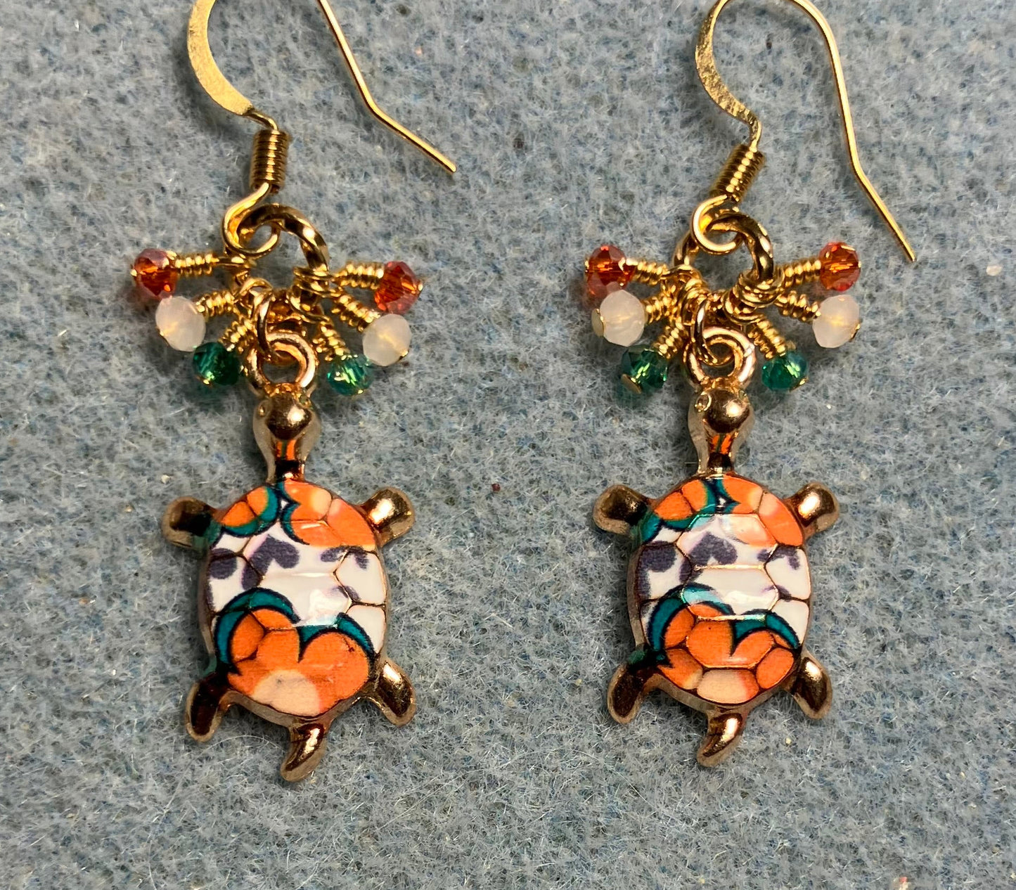 Orange, teal, and white enamel turtle charm earrings adorned with tiny dangling orange, teal, and white Chinese crystal beads.