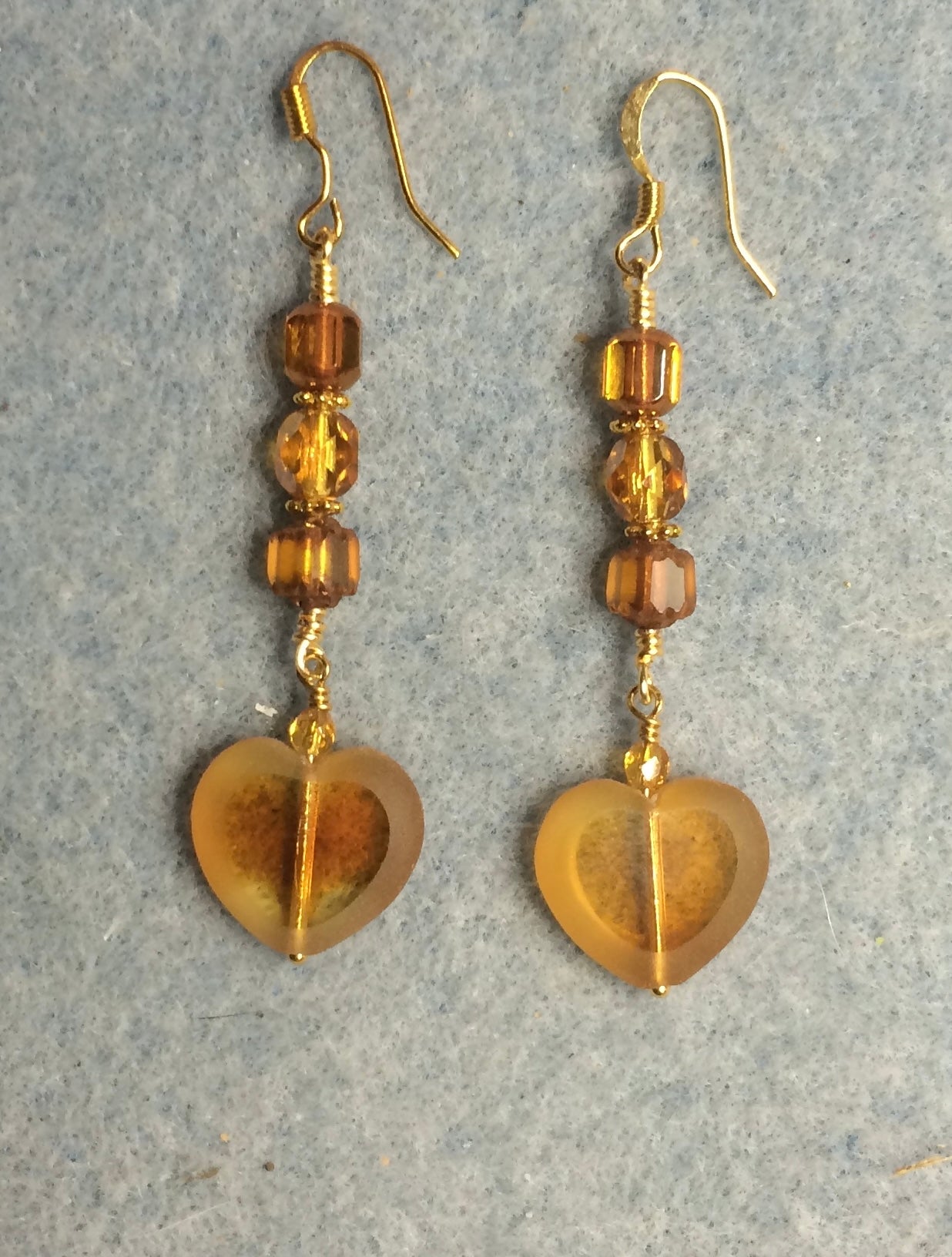 Amber Czech glass heart bead earrings adorned with amber Czech glass beads.